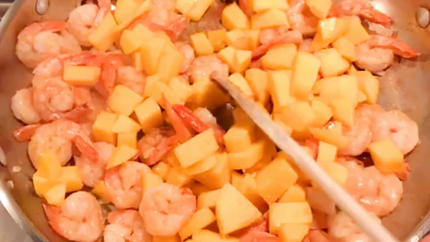 Add the mango and stir well