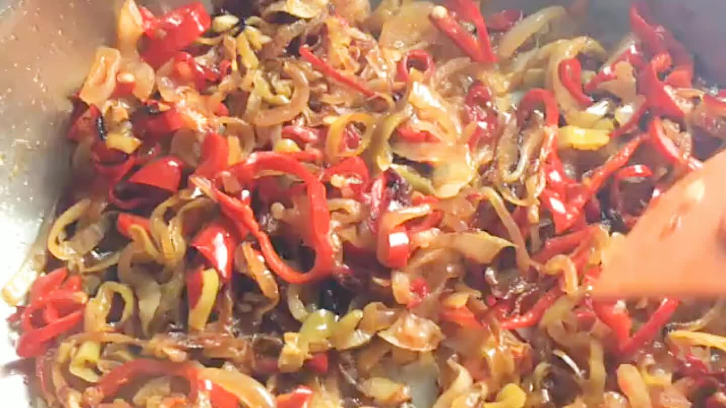 When the onion and peppers are tender, dump in the tomatoes. Simmer, stirring regularly.