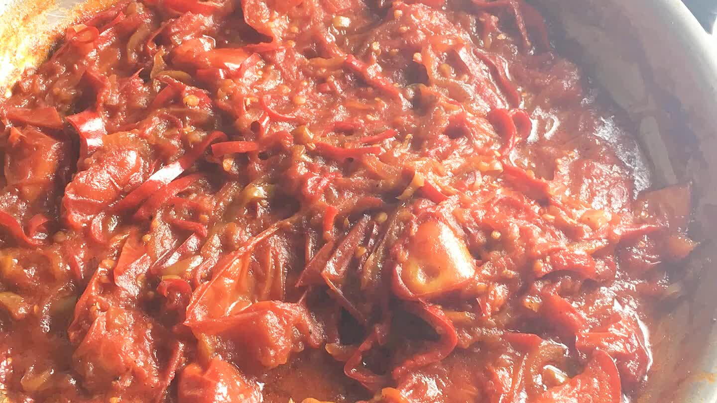 When the sauce is reduced to a stew like consistency, dig 4 little pits. Crack an egg into each.
