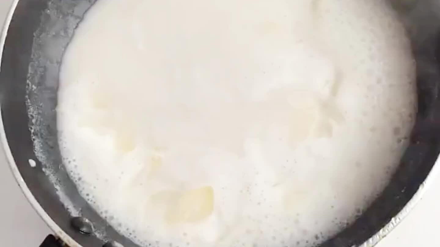 Strain and rinse the garlic slices. Repeat simmering and rinsing 4 times, using fresh milk each time.