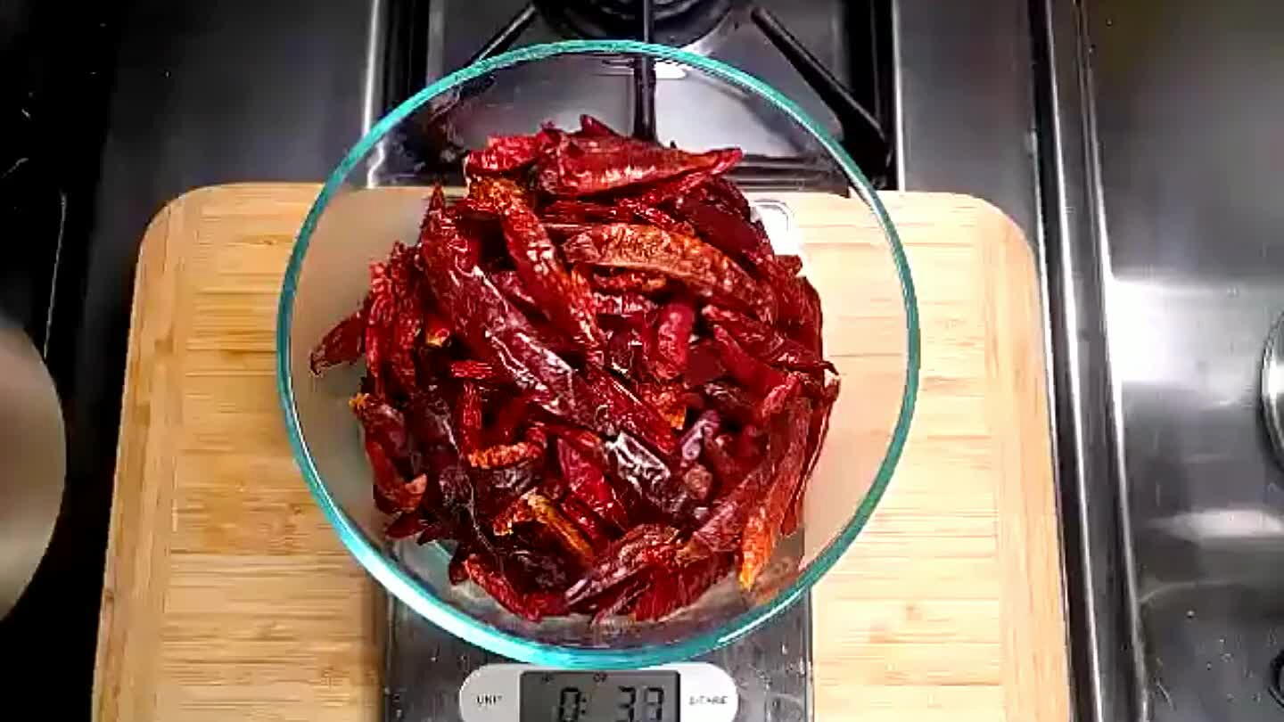 Soak the chilies for 30 minutes in hot water. I used a bowl and a strainer to keep them submerged.