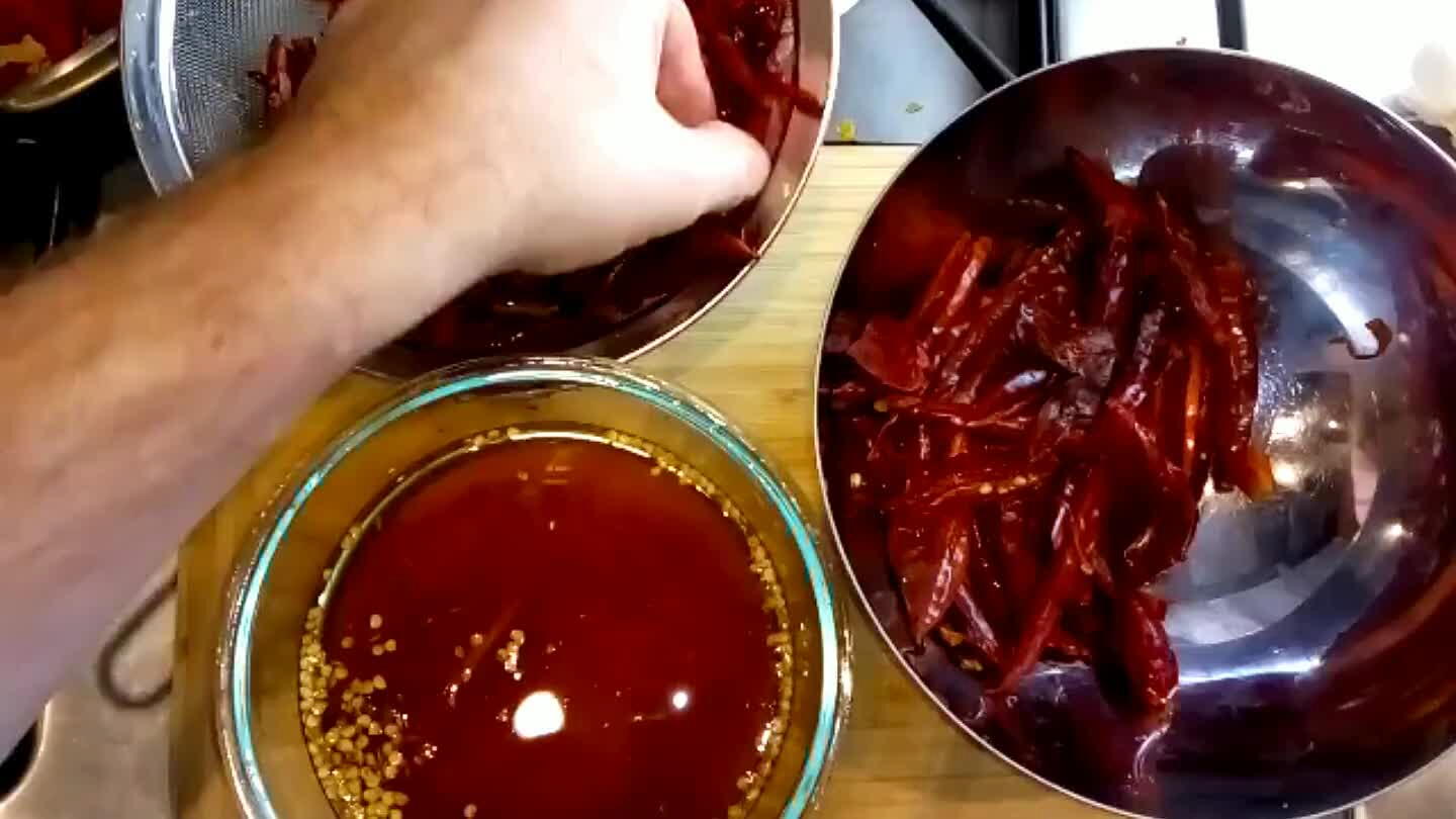 Probably should have worn gloves. I used a paring knife to split each chili and then rinsed the seeds out in a bowl of water. It's a lot of work. Took me about 30-45 minutes.