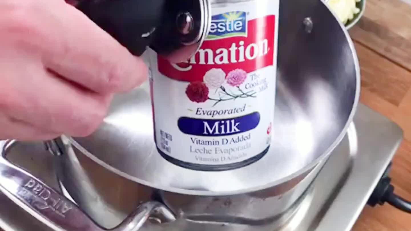 Melt the grated cheese gently into the evaporated milk.