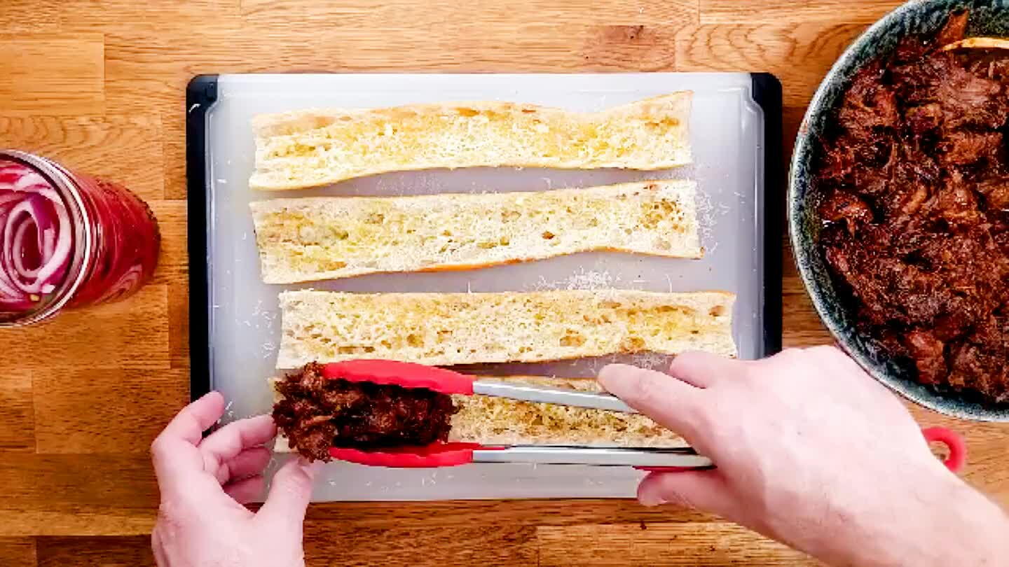 Lay out a thick layer of pulled pork.