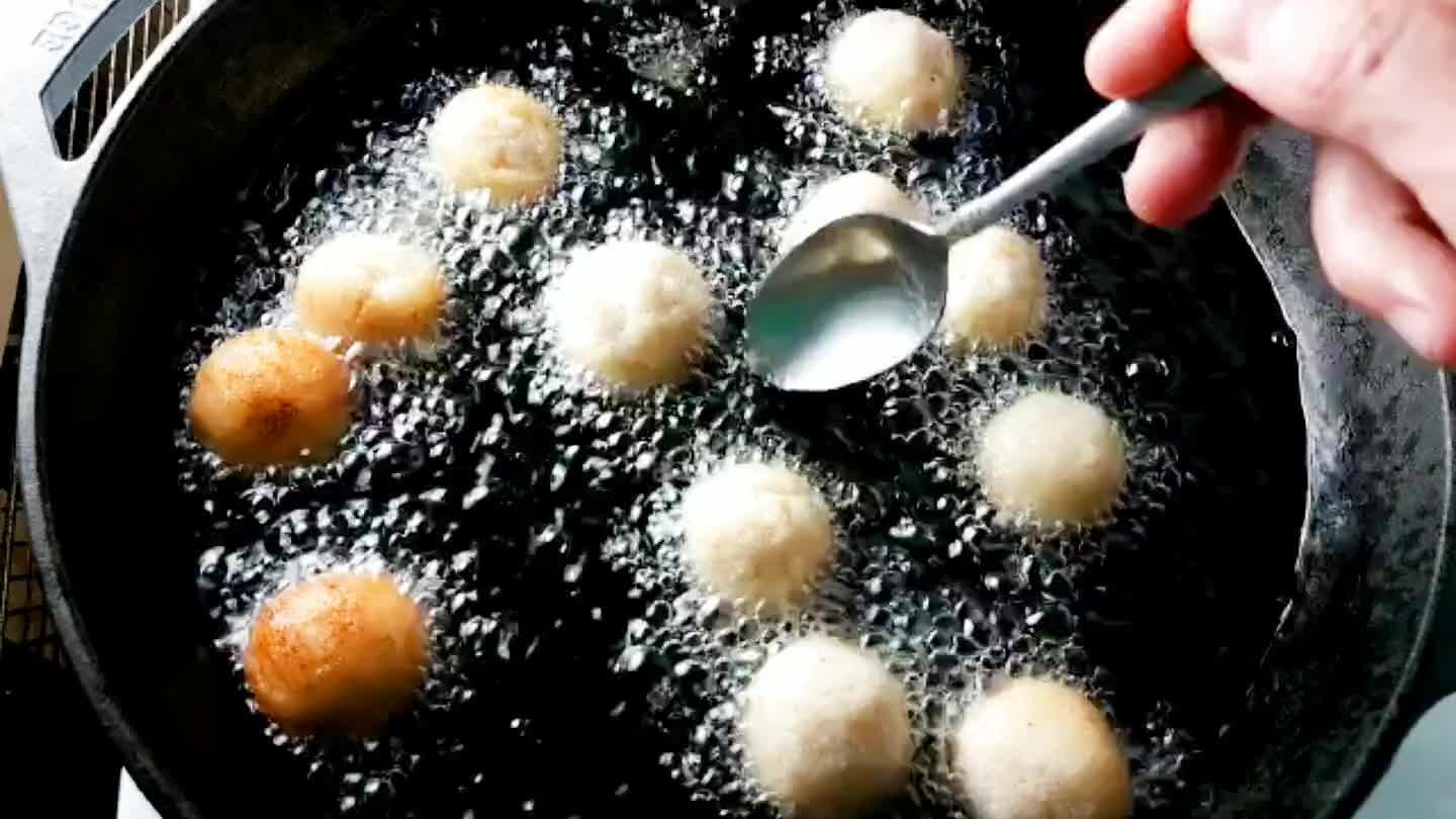 The balls may stick to th. To avoid this, try to hold each ball in the oil for several seconds before dropping. This cooks the outer skin just enough to keep it from sticking. I also used a spoon to gently shift each ball after firing.