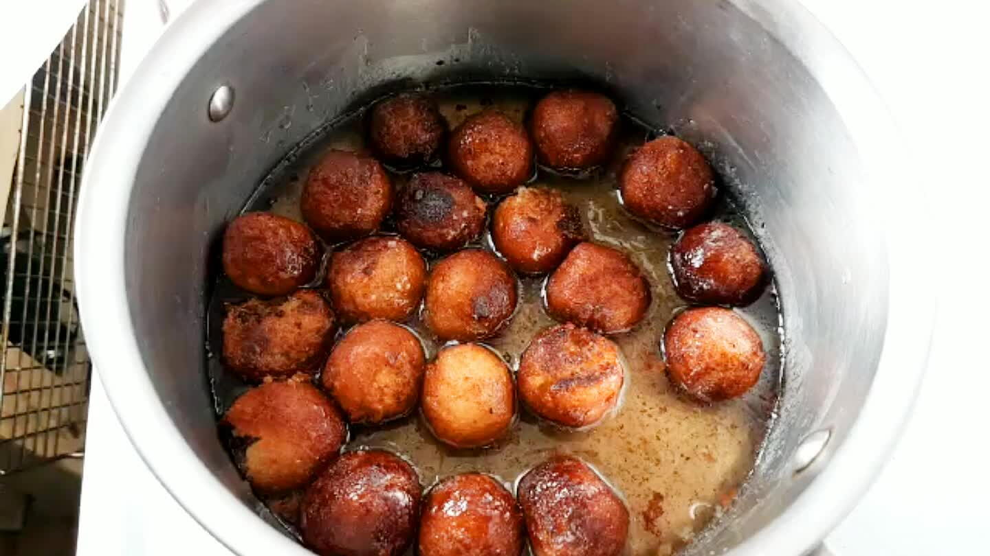 Transfer gulab jamun into the warm and waiting cardamom syrup. They're ready to eat. To serve, top with a light sprinkling of crushed nuts.
