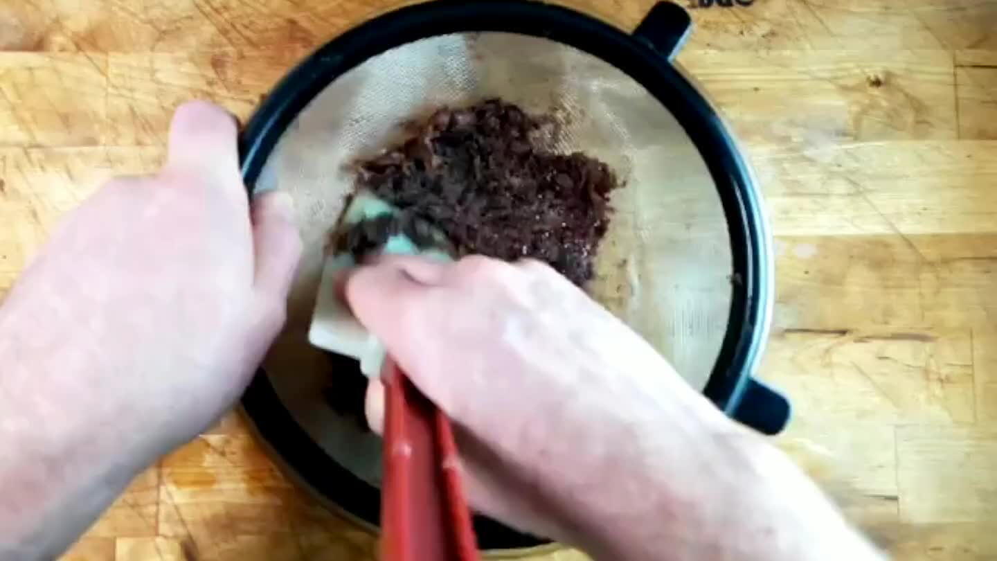 bit of work. The contents of the bean are pressed through, while the sheath of the bean mostly gets caught in the sieve.