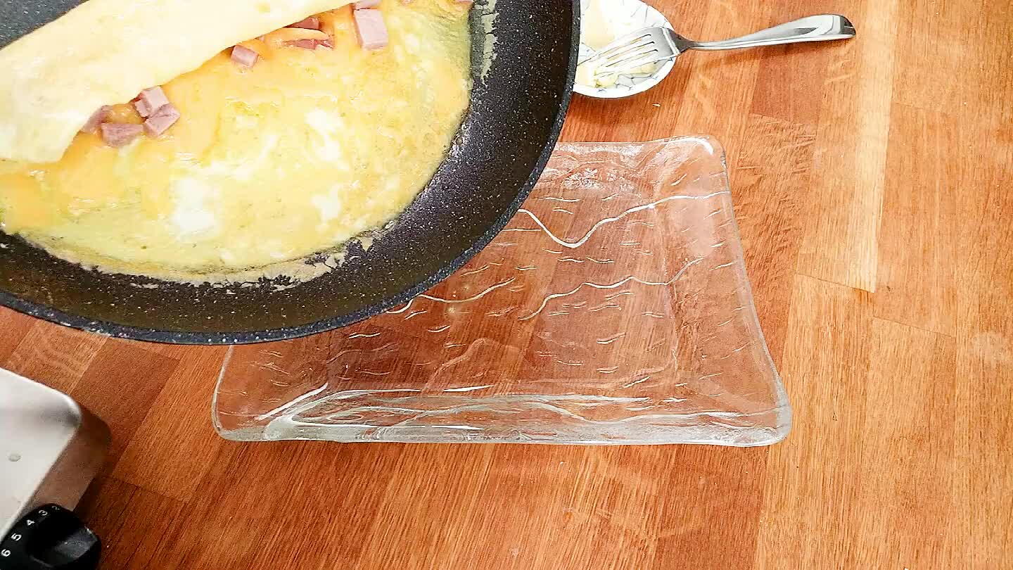 late. Continue guiding the egg to roll, then carefully drag the omelette out of the pan and onto a plate.