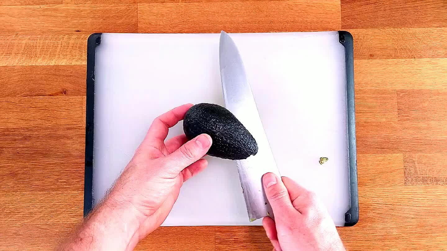 r line of the pit. Now, you don't move the knife, you move the avocado. Roll the pit of the avocado along the blade of the knife to slice in half perfectly.