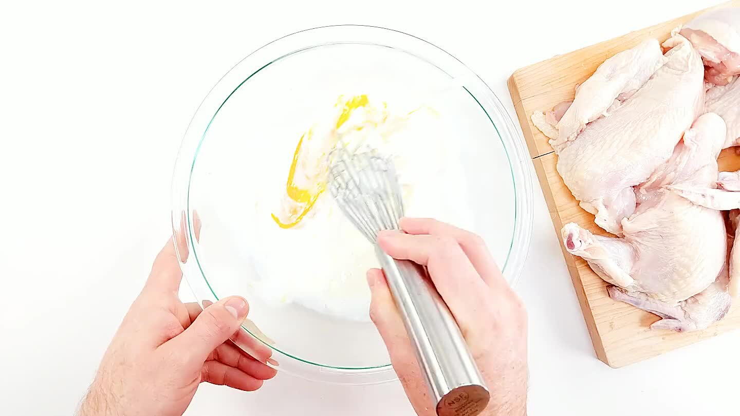 Crack the egg in a bowl and whisk in the buttermilk to make the chicken undercoat/marinade.