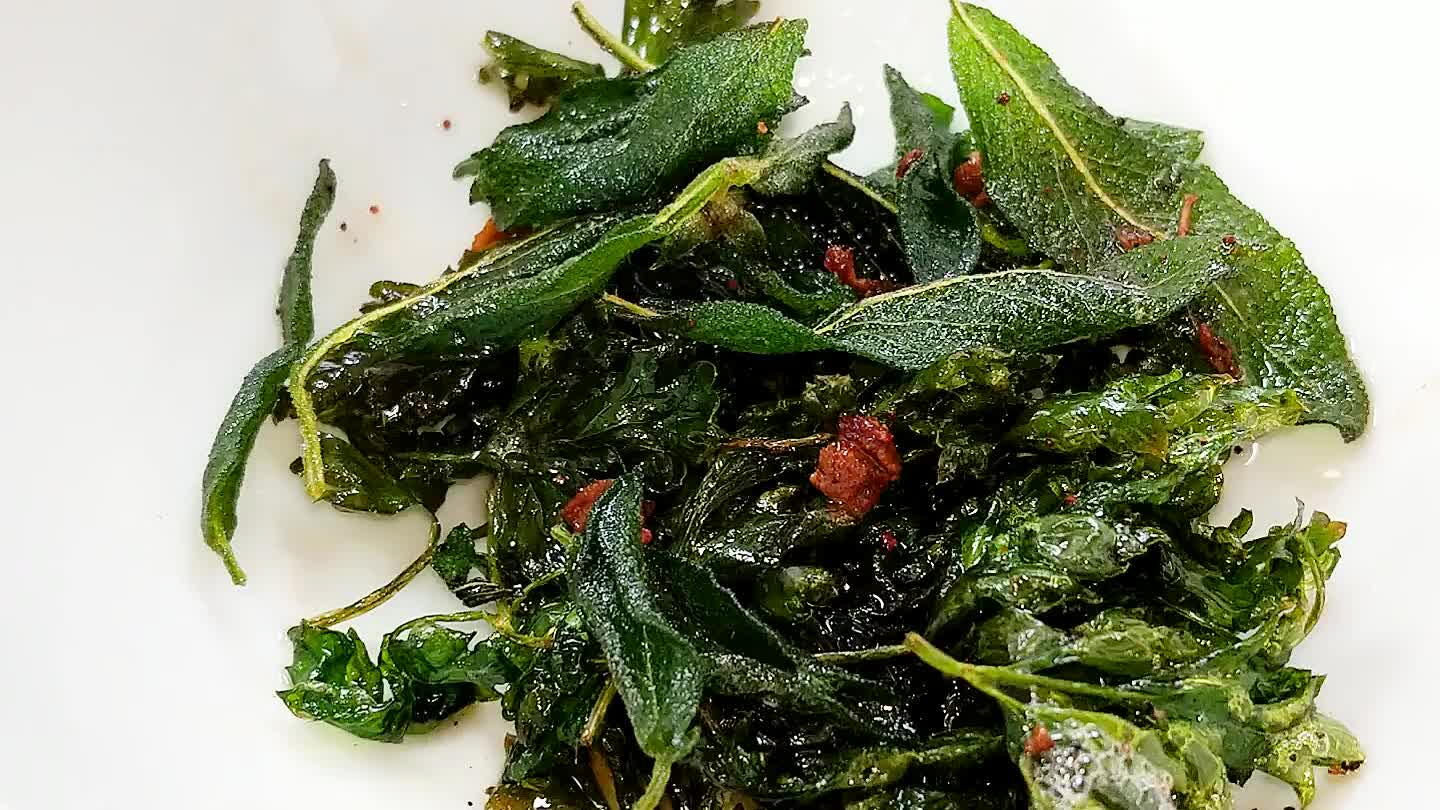 the hot oil. They will probably sputter a lot. Fry the herbs for about 30 seconds, just until translucent, then remove and drain.