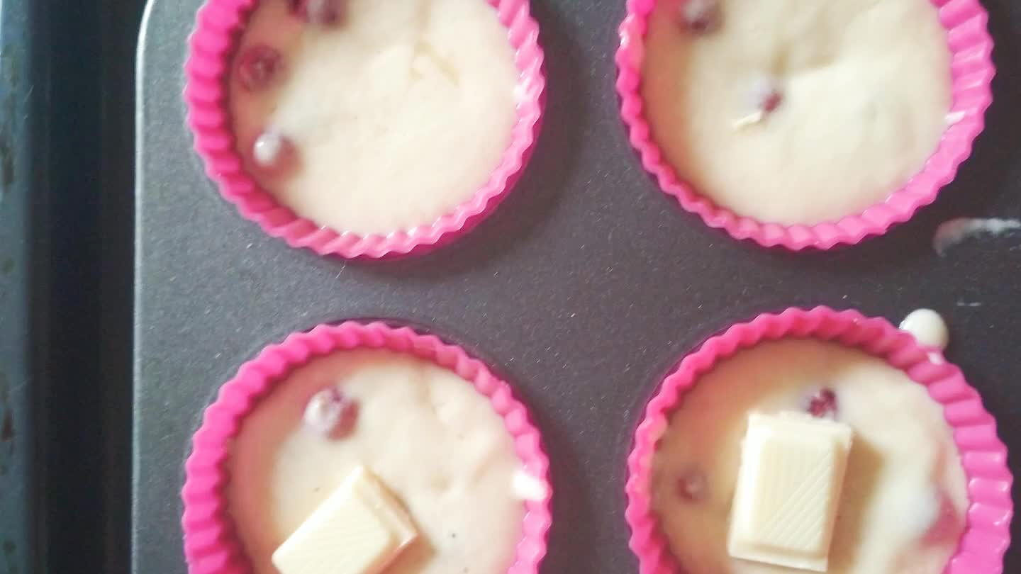 Nałóż ciasto do foremek. Całą lub pół kostki czekolady lekko wduś w każdą babeczkę. Piecz ok 20 minut w 180°C.