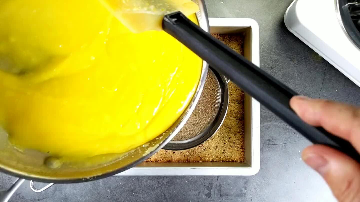 ave some little eggy clumps, so you will want to pass it through a fine strainer to make sure it stays smooth and silky. Use that spatula to stir and press the custard through the sieve.