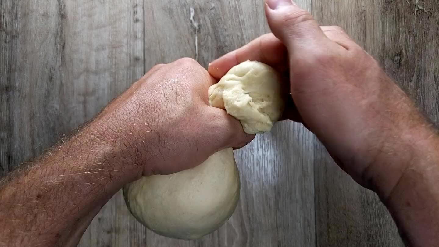 of the dough, slightly smaller than a racket ball, and close your thumb and forefinger tightly around it. Use your free hand to cut the portion away from the main ball. Repeat.