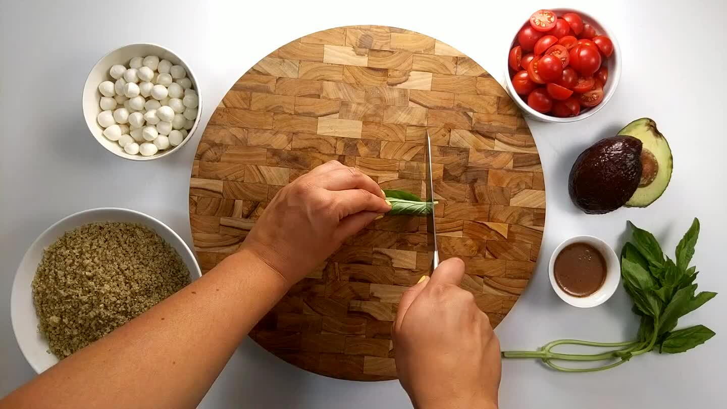 the roll of basil on the cutting board and slice in thin strips.