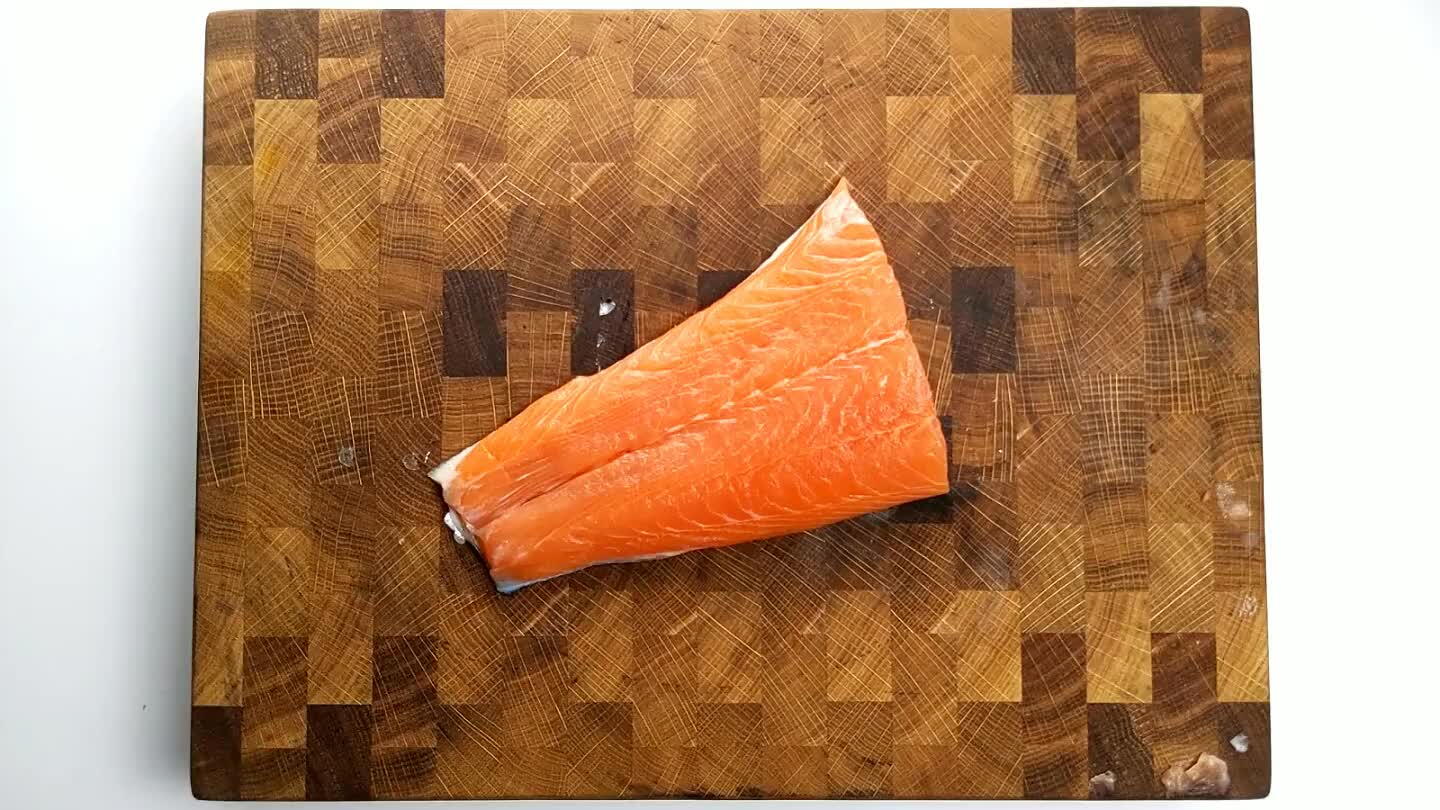 arly parallel to the cutting board, slice down into the narrower side of the fillet, stopping at the skin. With your free hand pinch the edge of the skin under the blade. Gently wiggle the skin, holding gentle pressure with the blade against the skin, allowing the blade to slice along the skin without breaking it.