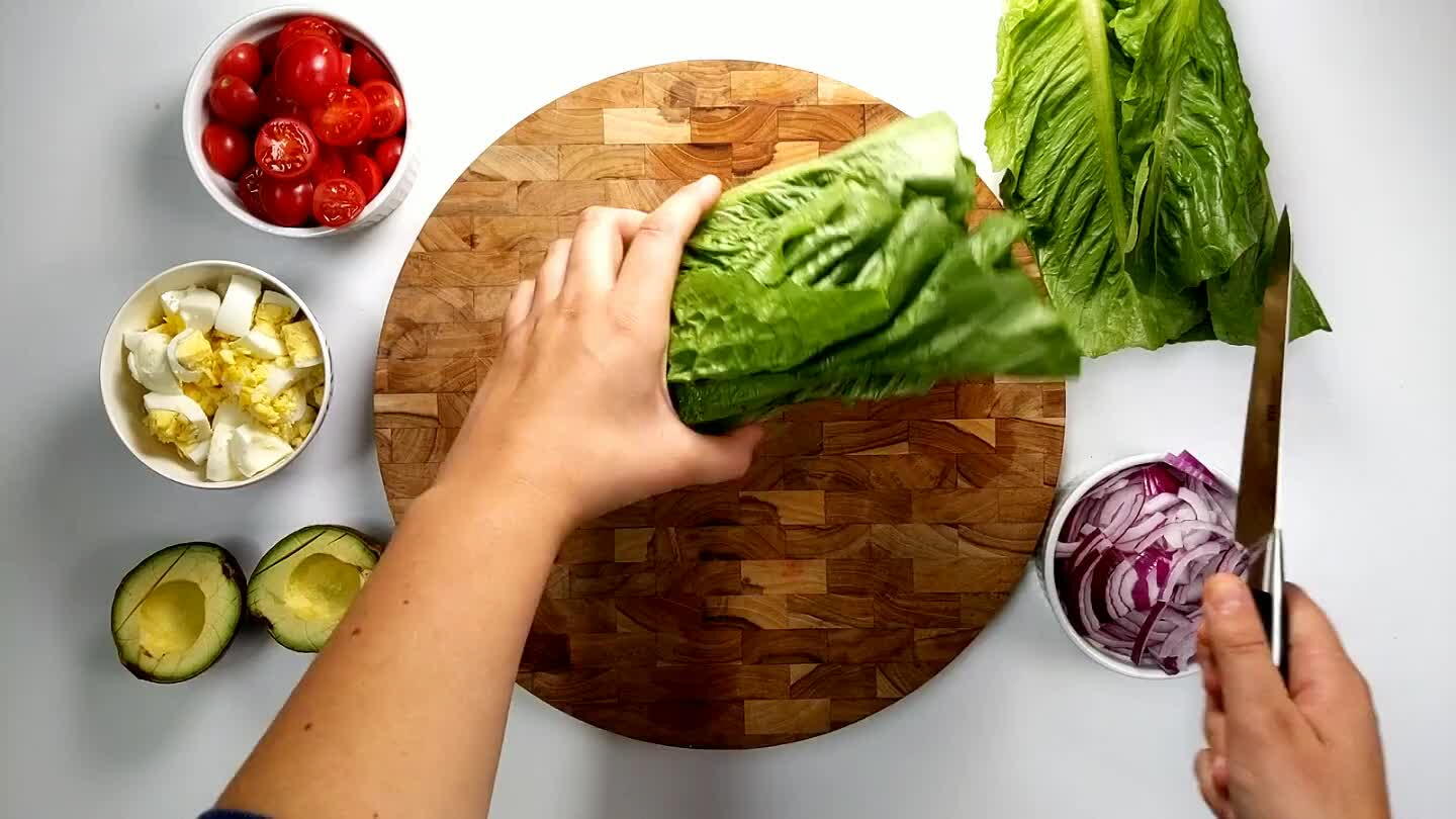 tact, and then slice into bite sized strips. Portion the romaine into four individual bowls, or use one large salad bowl.