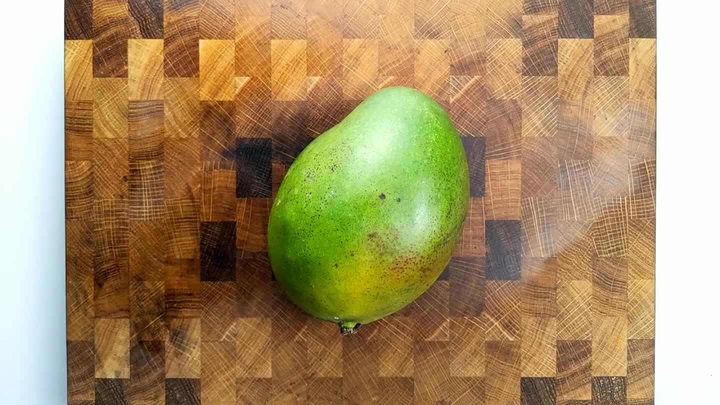 elf. Tilt the mango on its side so that it is symmetrical when looking down on it from above. Then, slice off the sides, avoiding the pit. With the center of the mango on its side now, follow the curve of the pit with your knife. to get at the rest of the mango flesh.
