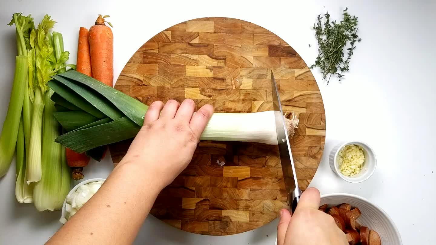 engthwise, keeping the top leaves in tact. Chop into half moons until you get into the thick green leaves.