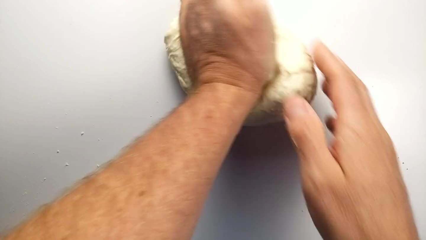timidating if you've never done it before, but it's quite simple. Just grab one edge of the dough ball, stretch it out and fold it back over into the main dough repeatedly.
