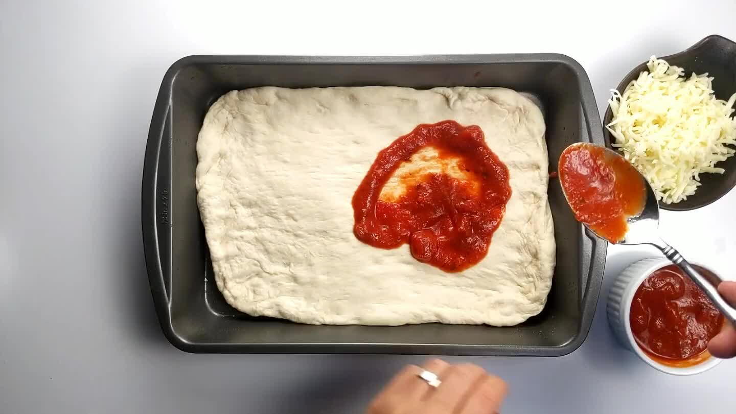 pizza should be topped right up to the wall of the pan.