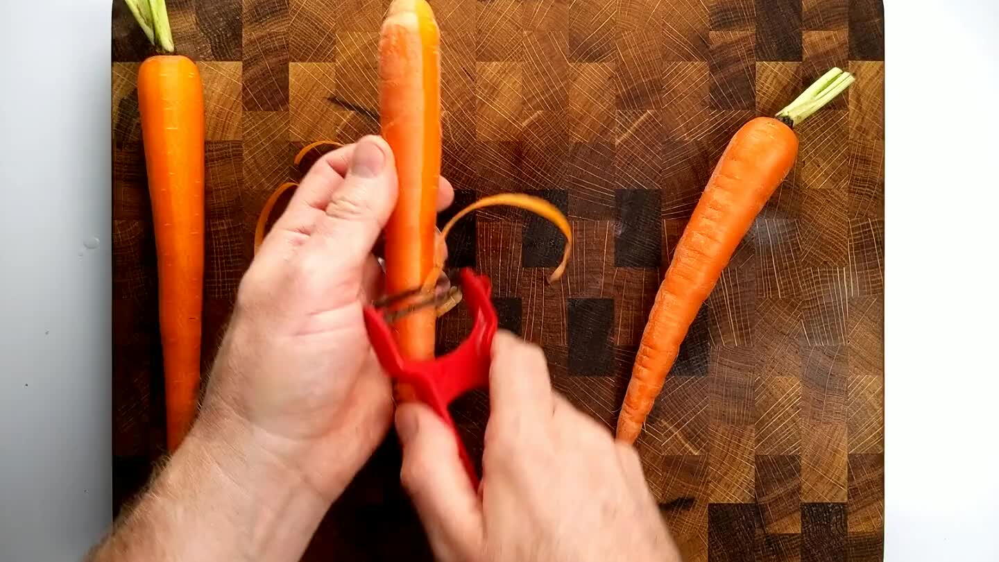 is called a roll cut and it just randomizes the shape of the carrot a little to make things more interesting. It also tends to help you keep the carrot chunks at similar sizes if you do it right.