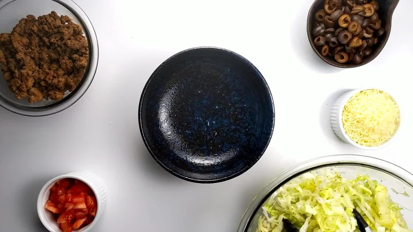 to let everyone make their own taco bowl. Start with some lettuce.