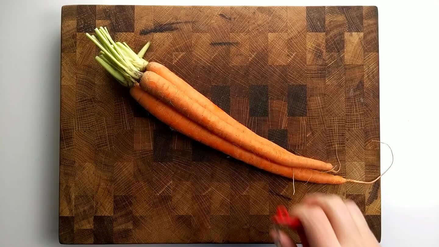 is called a roll cut and it just randomizes the shape of the carrot a little to make things more interesting. It also tends to help you keep the carrot chunks at similar sizes if you do it right.