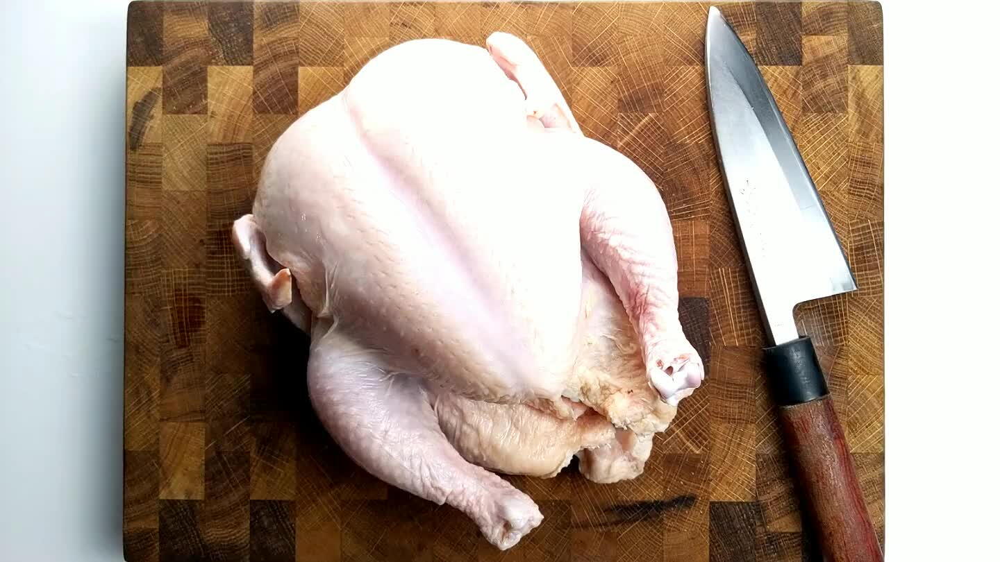 ge the chicken on a cutting board. You'll need a pair of scissors or a sharp and heavy knife.