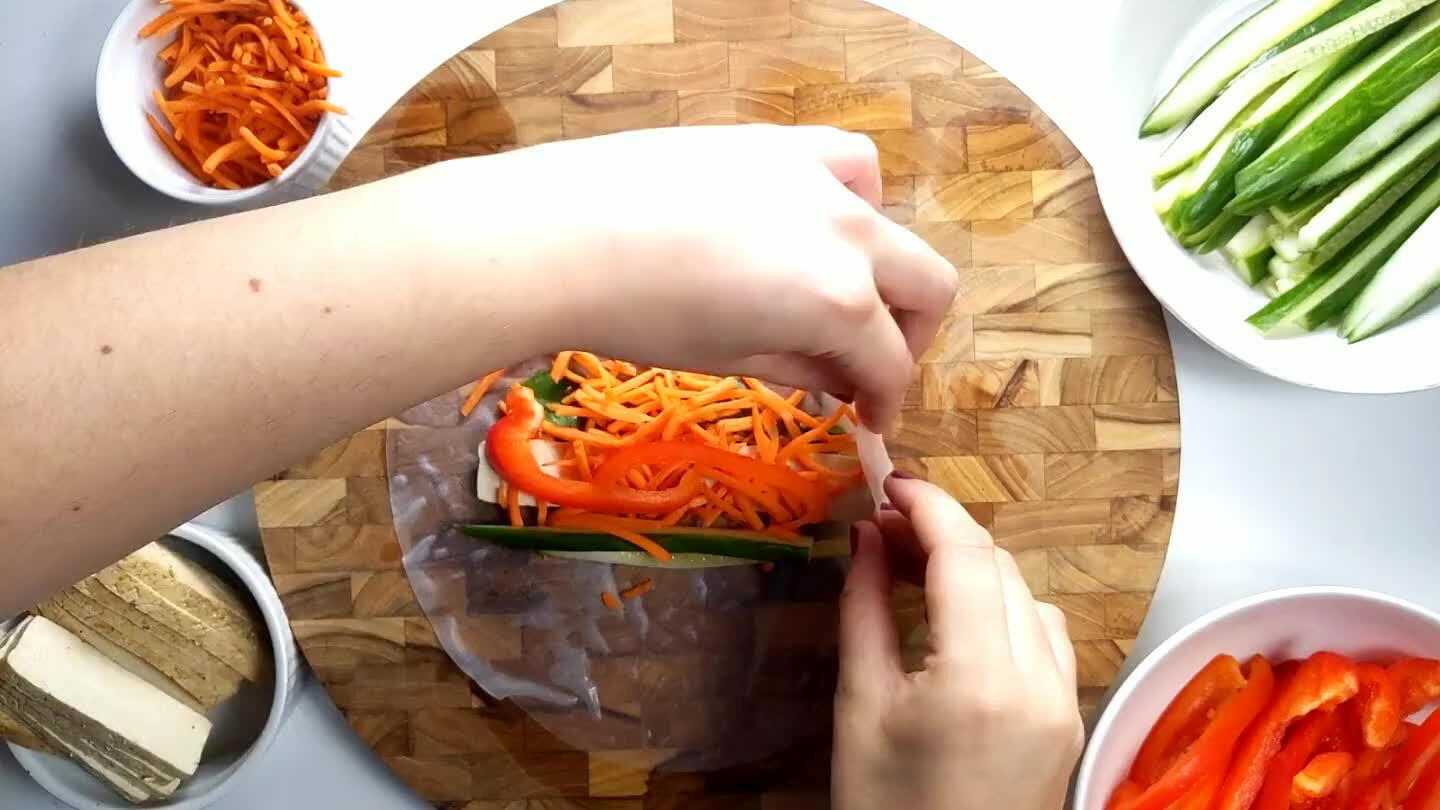 front flap over the top of the veggies, tuck it in and roll away from you to complete the wrap. Everything will stick together. Set aside and repeat.