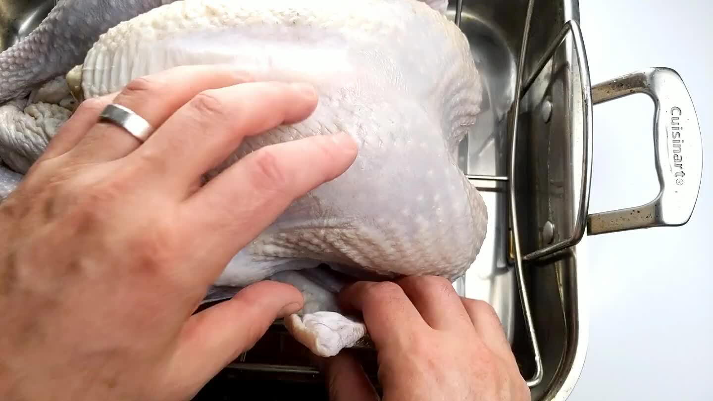 back. With the legs, often there's enough extra skin at the bottom of the cavity that you can just slice a small hole in it and tuck the legs through to hold them in place. Otherwise, tie them together with a piece of butcher's twine. Holding the thighs close to the body will help keep them from cooking too much faster than the breast.