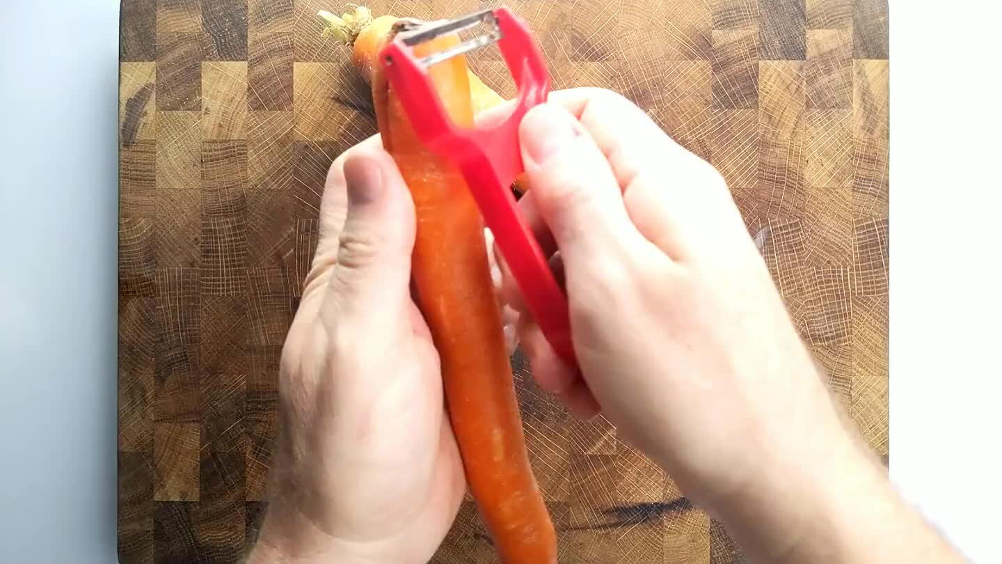is called a roll cut and it just randomizes the shape of the carrot a little to make things more interesting. It also tends to help you keep the carrot chunks at similar sizes if you do it right.