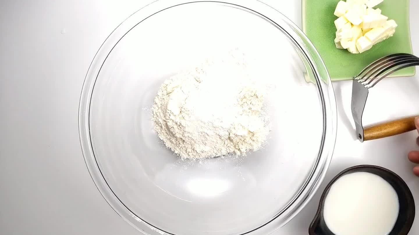 helpful here. If you don't have one, you can also grate the butter and cut it in with a fork. What you're looking for is a sandy crumble. When you squeeze it together it should crumble like weak sandstone. It's okay if some small butter clumps remain.