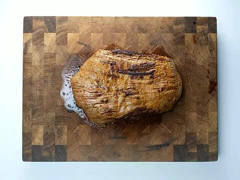 Like a piece of bare wood, the pattern of muscle in the meat will align in an obvious direction. It's particularly apparent in this slab of flank steak.