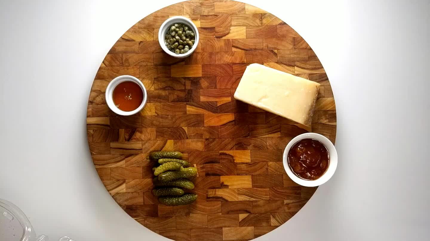 d olives, cornichons, and almonds to the board, and place jam and honey into small containers.