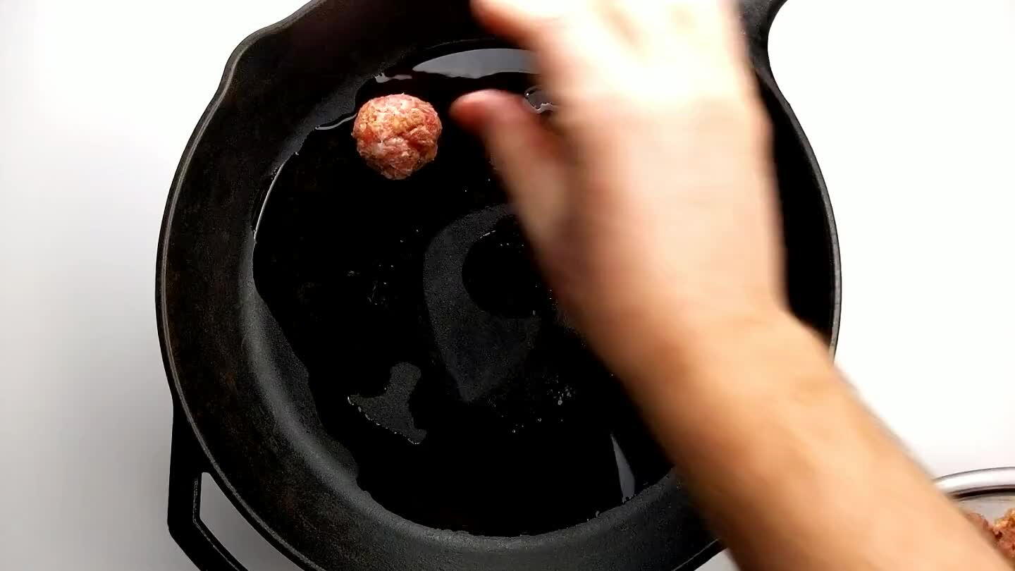 an begin adding the meatballs. Cook each meatball until crusty and caramelized on one side.