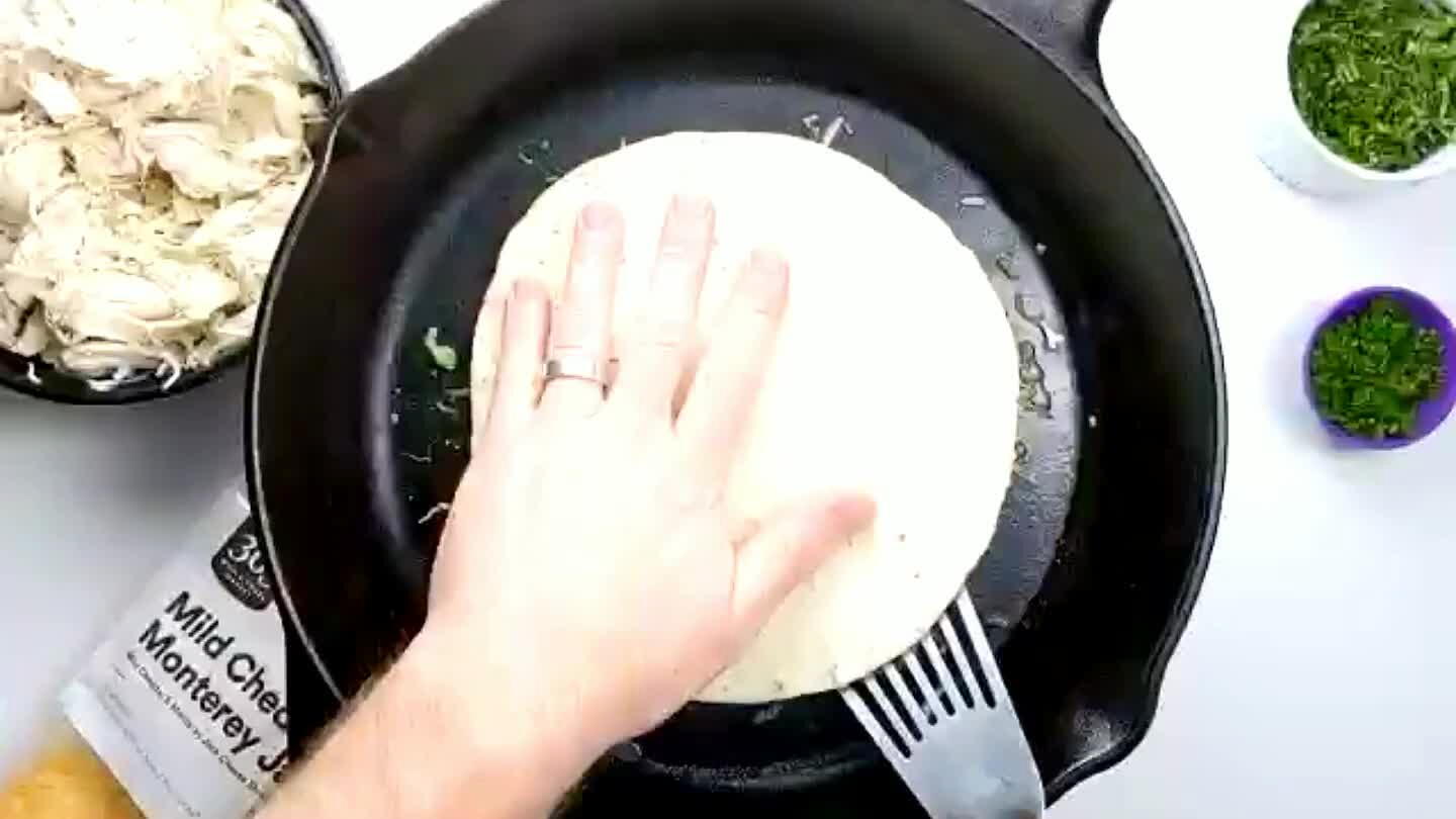 to flip the quesadilla. Lift an edge to make sure the bottom tortilla is toasted a little. You gotta move quick when flipping quesadillas. Cook the opposite side. Once the cheese is melted and both the top and bottom tortillas are golden brown, transfer to a cutting board to slice into wedges.