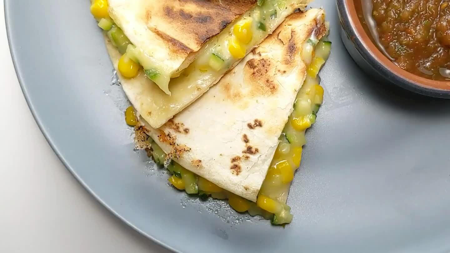 to flip the quesadilla. Lift an edge to make sure the bottom tortilla is toasted a little. You gotta move quick when flipping quesadillas. Cook the opposite side. Once the cheese is melted and both the top and bottom tortillas are golden brown, transfer to a cutting board to slice into wedges.