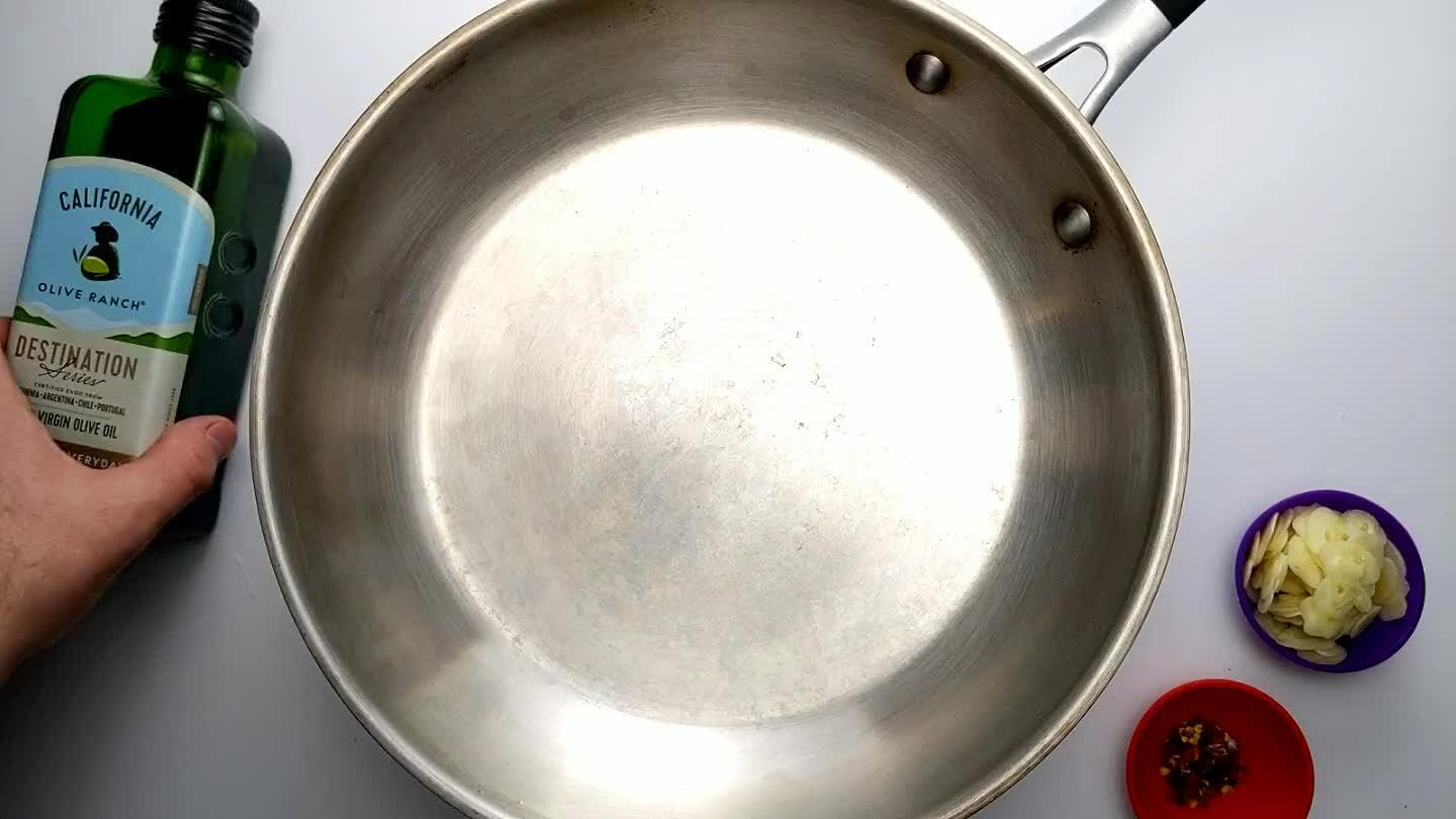 ur of olive oil over medium heat until it shines. Add a small slice of garlic to the pan. If it bubbles, it's hot enough to move on to the next step.