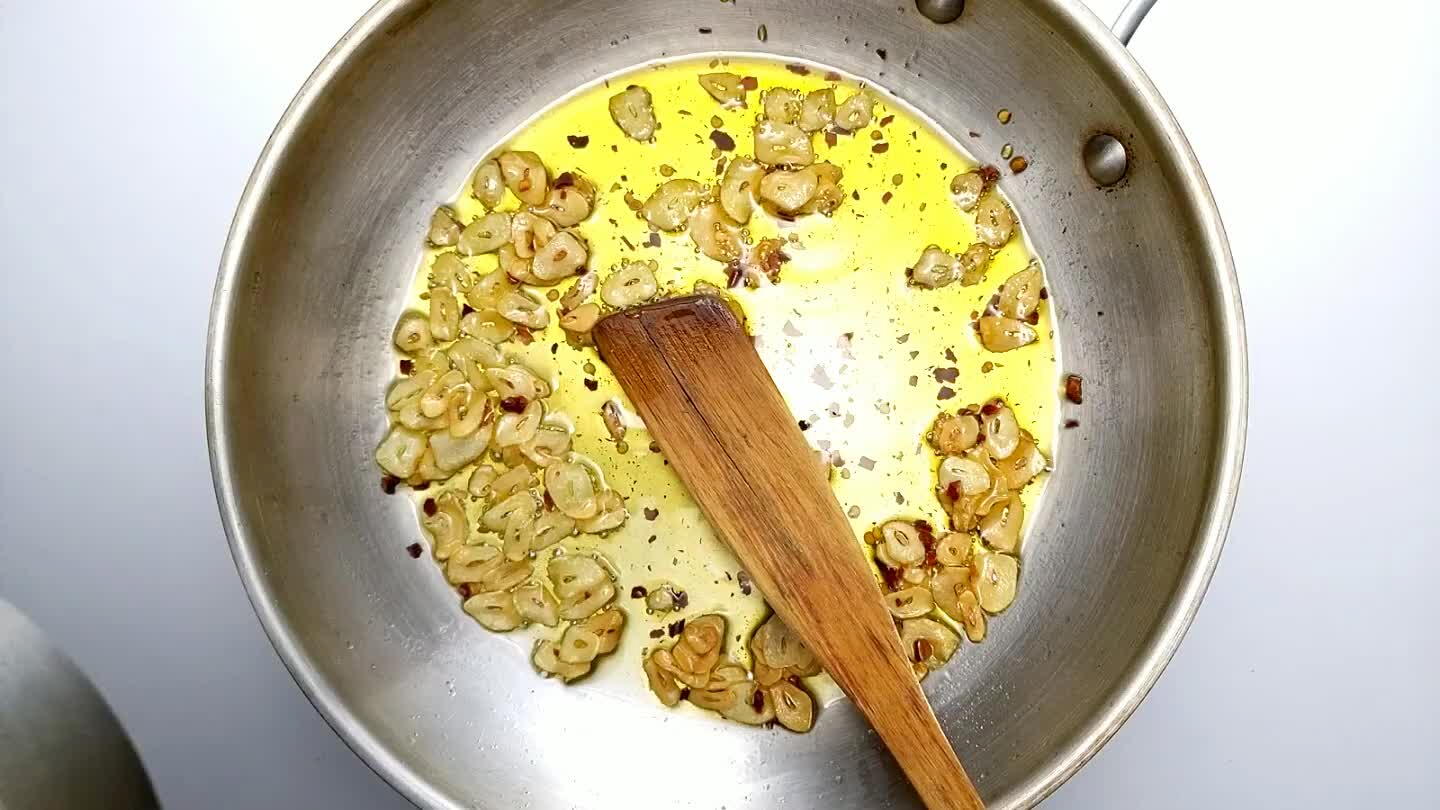 lly, the oil will still be warm from cooking the garlic). Add about a cup of pasta water. Stir to coat the noodles in the garlic chili oil. Turn off the heat.