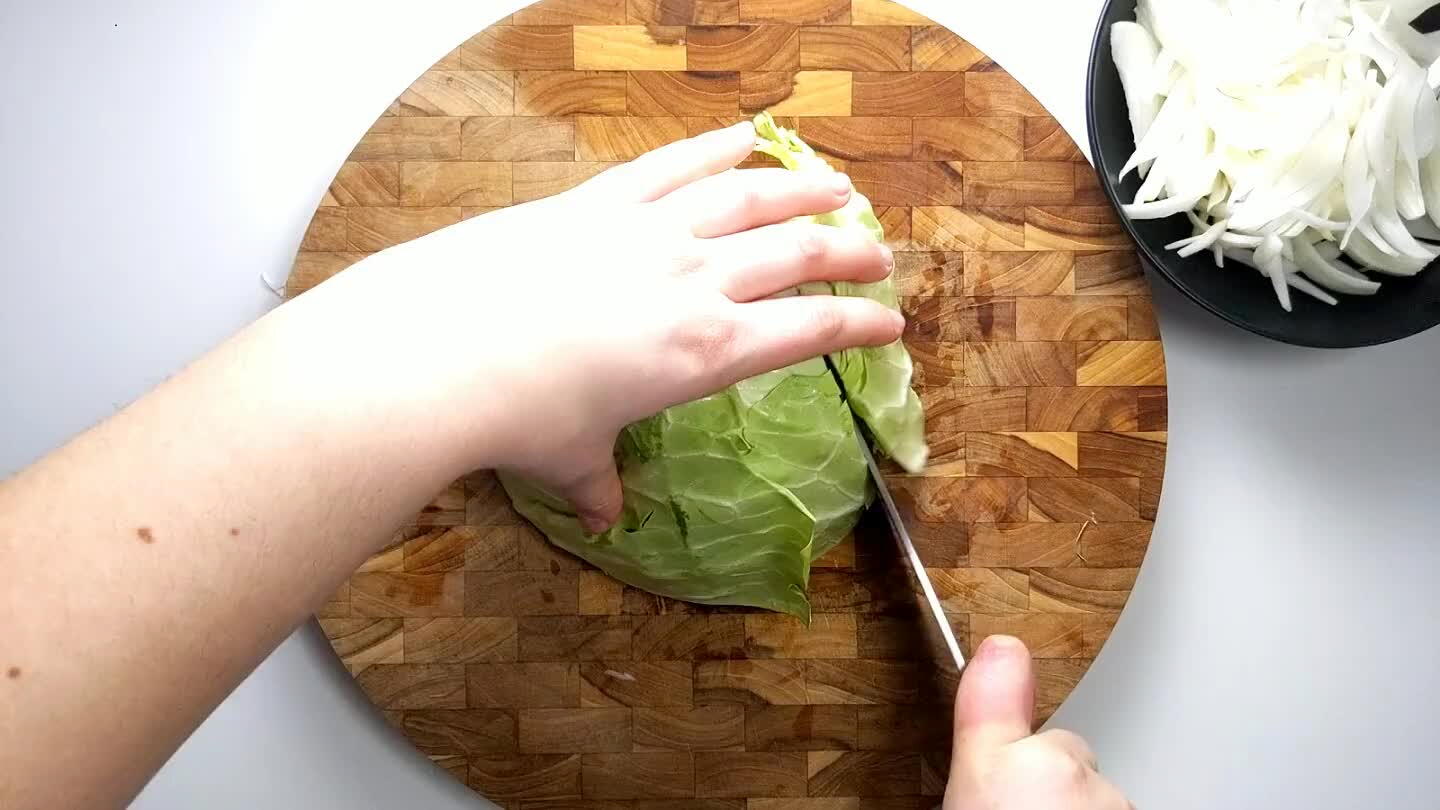 f the head. Cut in half and cut 3 scores into the cabbage leaving the stem side in tact. Chop super thin strips to create shreds of cabbage.