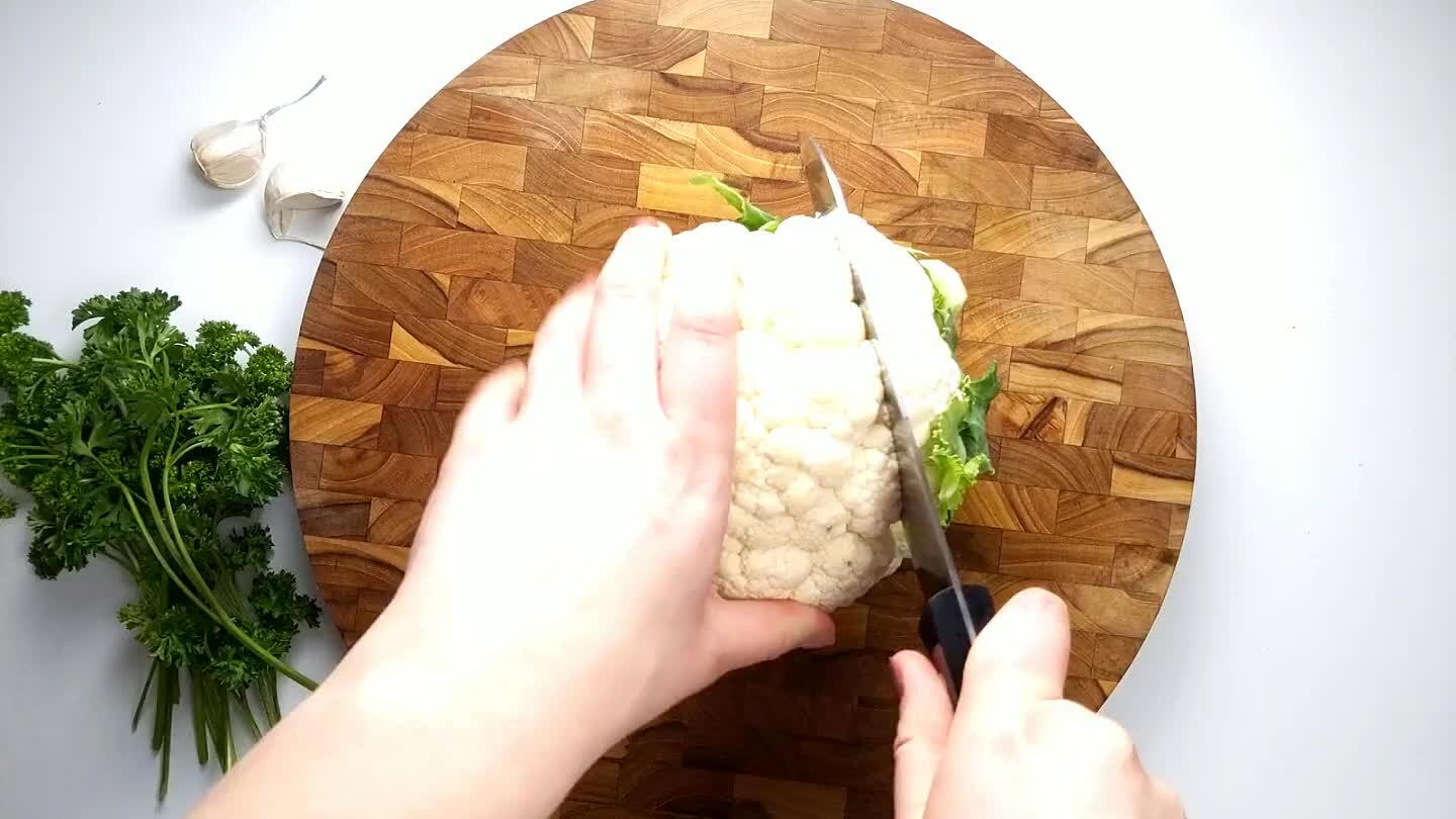 f the cauliflower leaving just the middle. Don't worry about removing the leaves just yet. Cut the middle portion in half leaving two 1 inch cauliflower steaks. Then cut just the leaves from each steak. Reserve the leftover cauliflower to roast alongside the steaks.