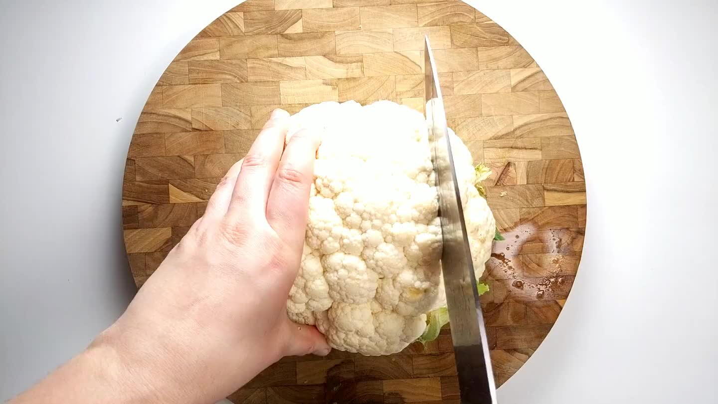 through the center of the cauliflower to divide it in half. Now cut each half into two 3/4" thick slices. Save the ends to eat as a snack or serve with salad.