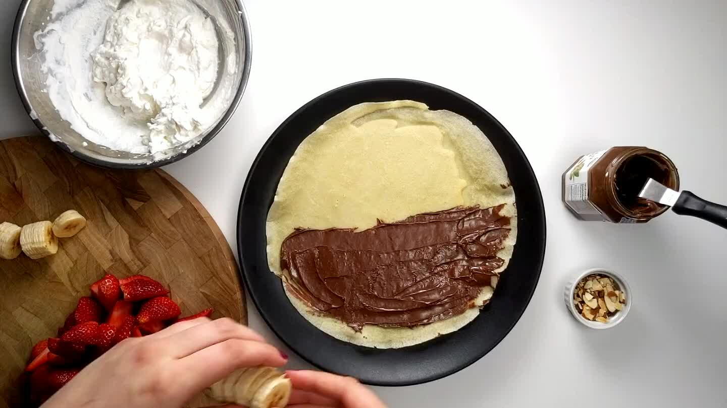 layer. Fold the crepe over the bananas in half, and then into a fan shape. Top with strawberries.