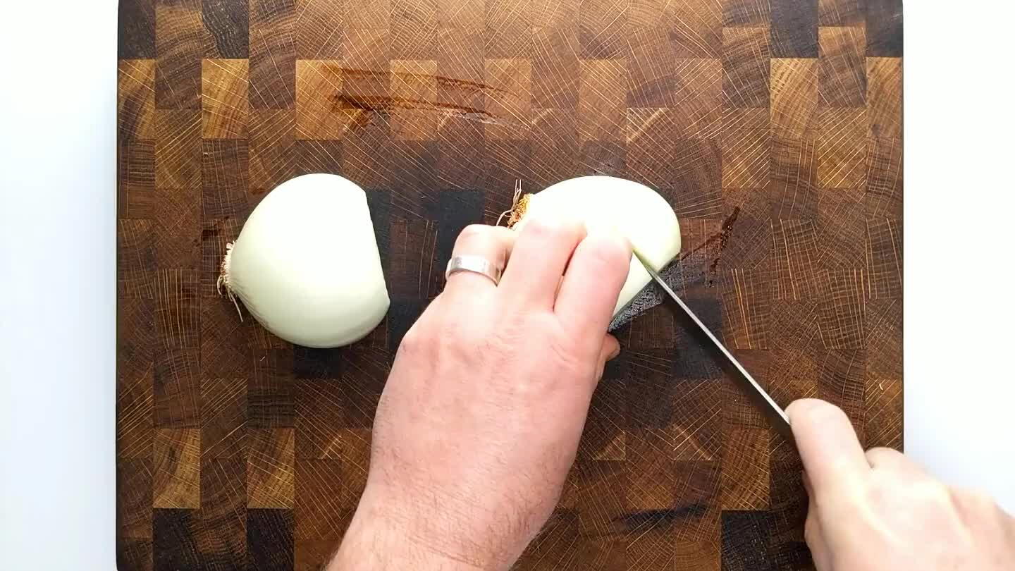 from the top, perpendicular to the sliced stem face without cutting through the root end. Slice again from the top, perpendicular to the previous slice to chop.
