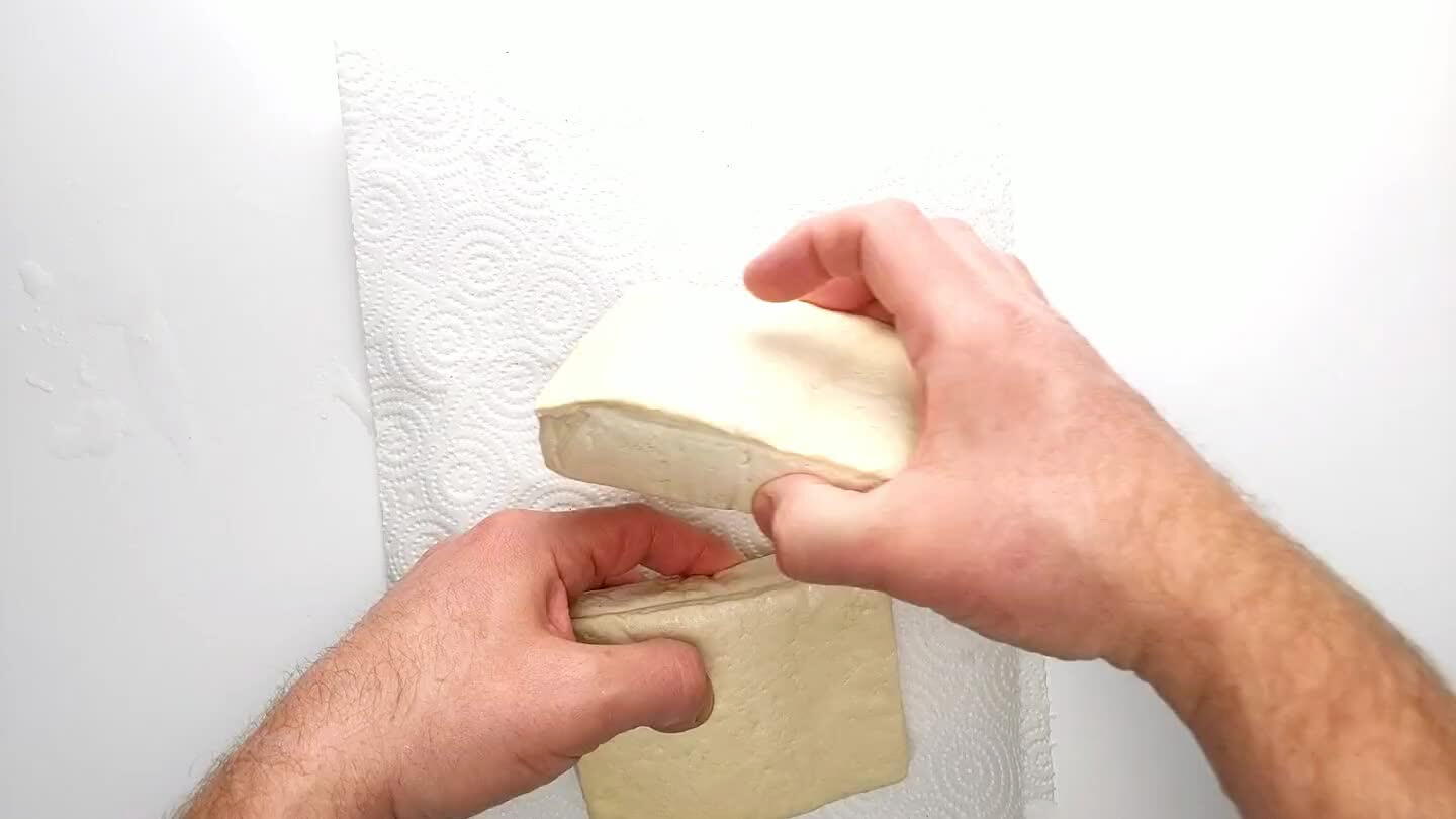 a wooden cutting board, but a heavy skillet or a plate and a few cans of beans will work great. Let it sit for 5-10 minutes.