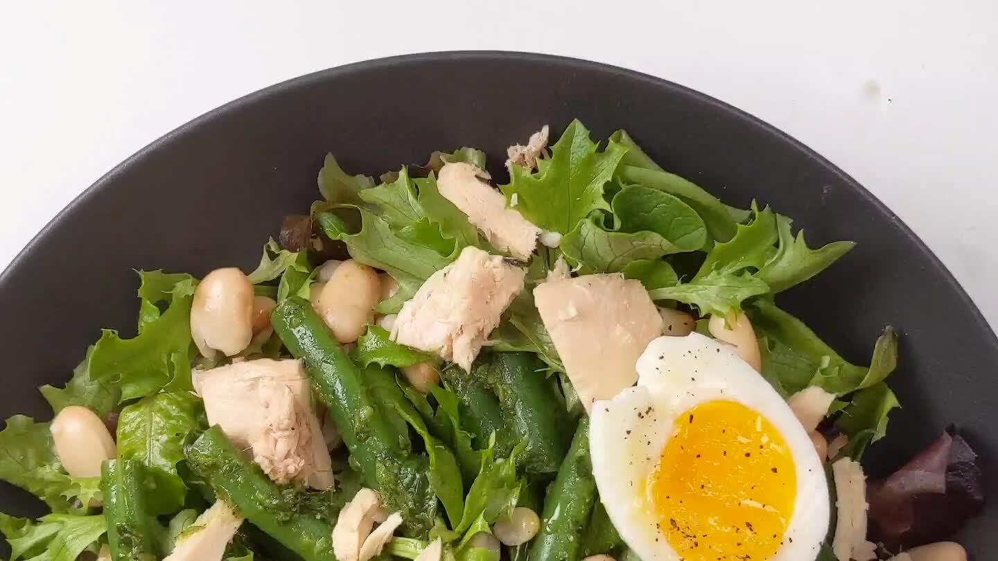 and green beans with basil vinnaigrette. Then carefully cut open one soft boiled egg per salad to plate.