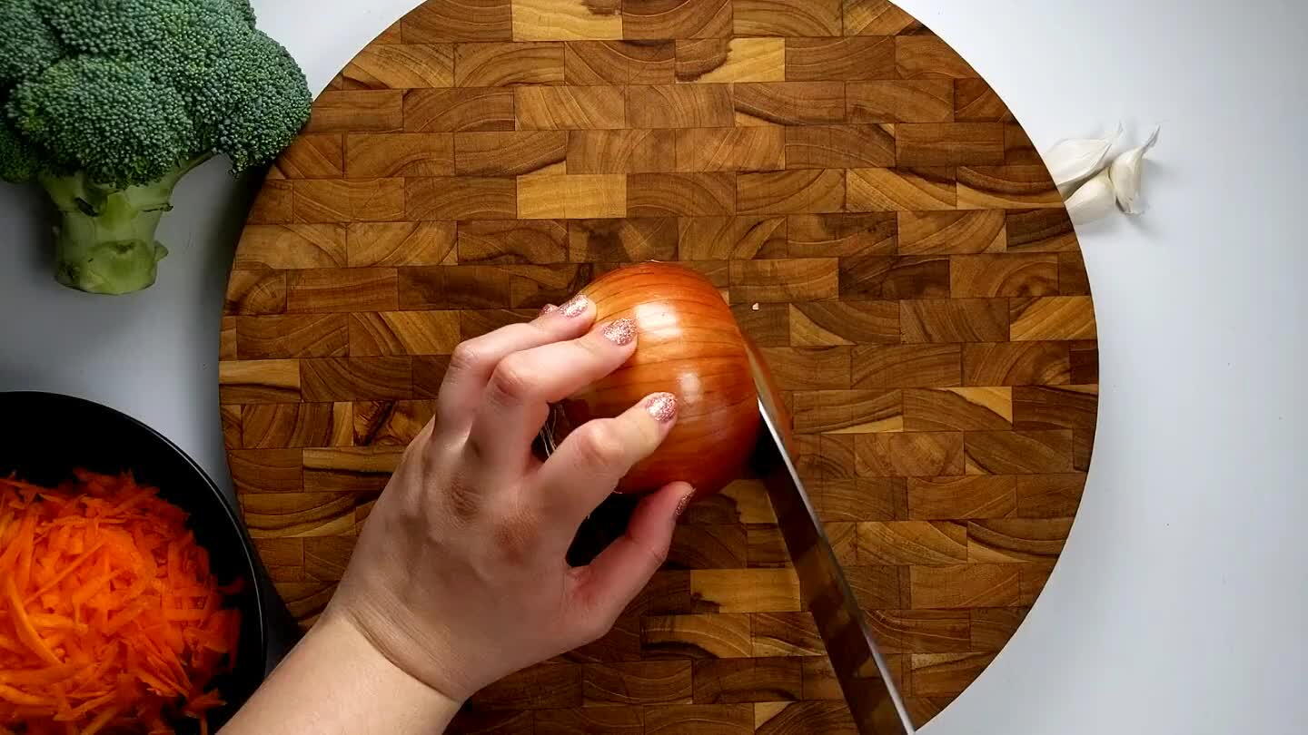 into the stem face several times with the blade parallel to the board. Slice into strips from the top across the onion, then turn and dice.
