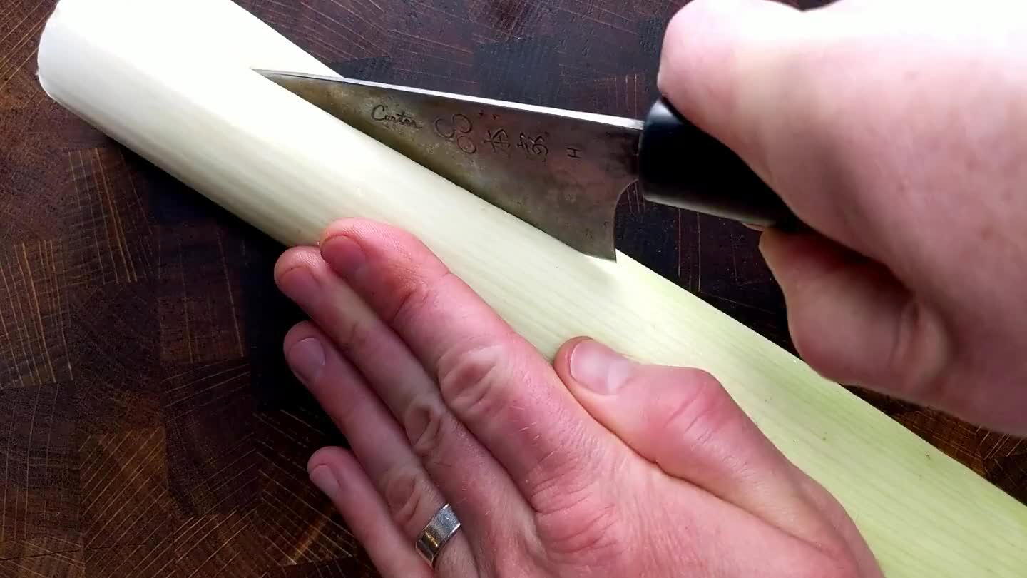 Slice the body of the leek in half lengthwise. Rinse to remove grit from the tightly layered sheets. Slice to about 1/4"