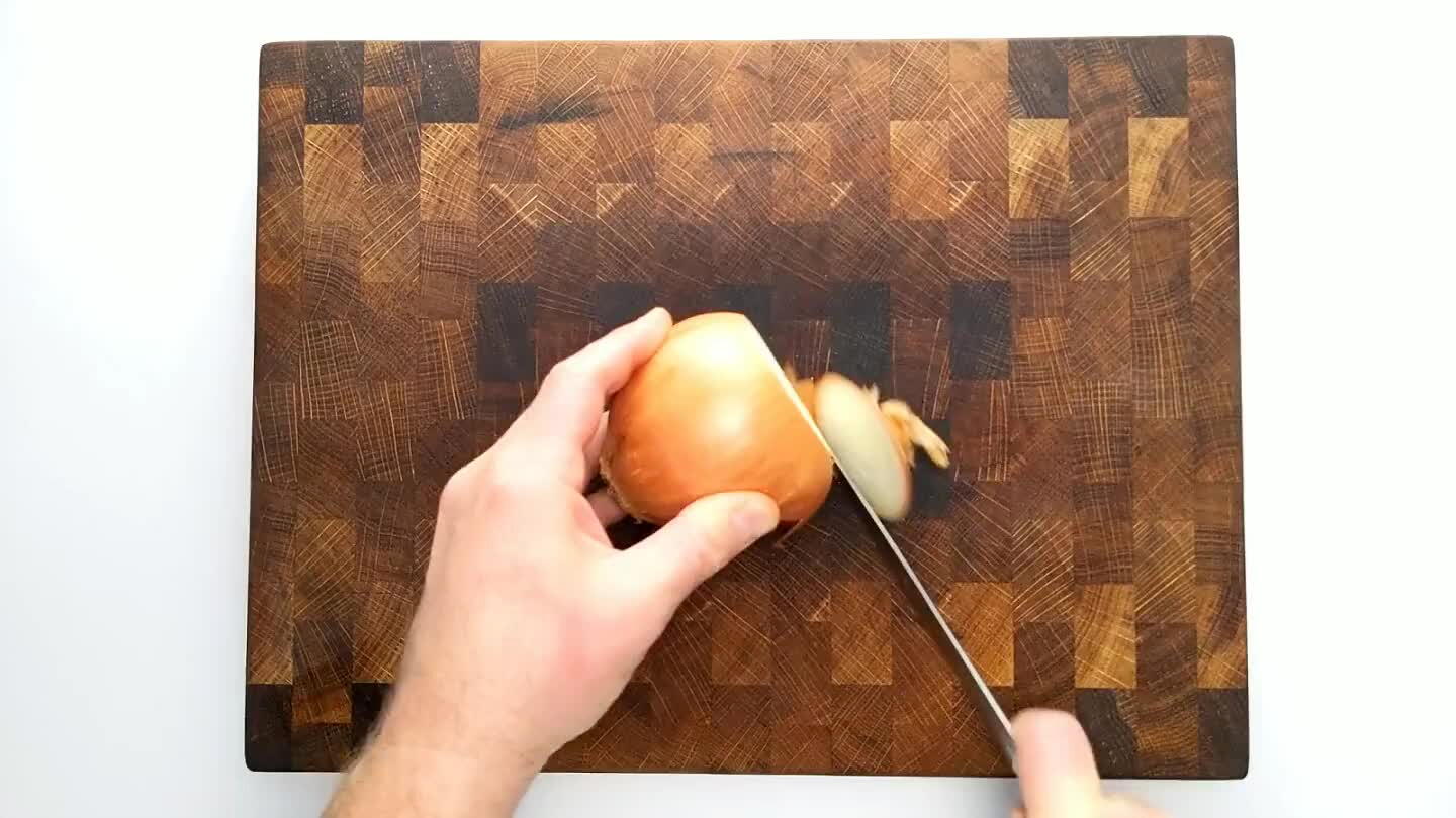 finely from the top, perpendicular to the sliced stem face without cutting through the root end. Then slice into the stem face several times with the blade parallel to the board to complete a hatch pattern. Slice again from the top perpendicular to the previous slice to dice finely.